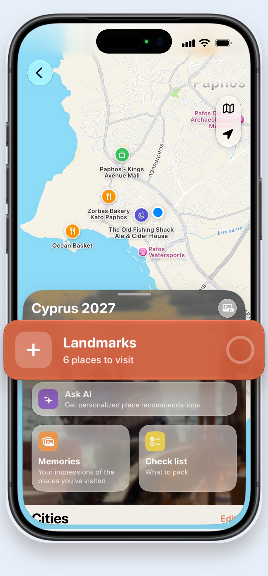 A trip map of Paphos with restaurants and a mall pinned, and a Landmarks card with 6 places to visit